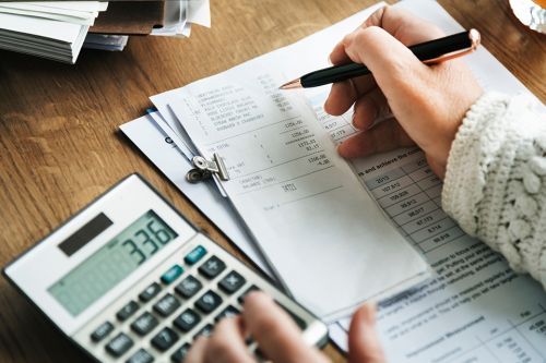 Person arbeitet am Taschenrechner